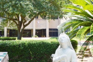 A statue near the main entrance to Christus Southeast Texas- St. Mary hospital in Port Arthur looks to the sky while holding a rosary.