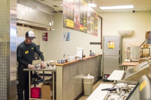 A Dickey’s Barbecue Pit employee wraps freshly smoked brisket before the restaurant opens for business Thursday morning in Nederland.