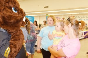 Gena Phelps, right, introduces her 2-year-old niece Kaelyne Linscomb to Nederland High School mascot Big Ned during the 10th annual NISD health fair Monday morning at C.O. Wilson Middle School.