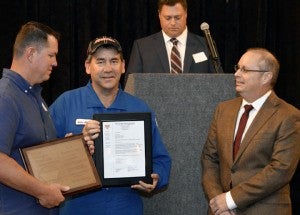 Representatives of Newtrron Beaumont LLC, left and center, receive a safety award for Medium Specialty during the 24th Annual Contractor Safety Awards sponsored by the Golden Triangle Busines Roundtable at the Holiday Inn in Beaumont on Tuesday.  Mary Meaux/The News