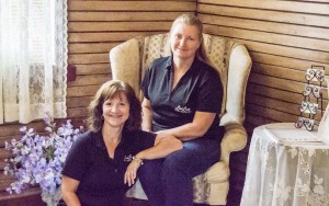 LoriLens Photography owner Lori Cappel, left, and her assistant Eva Simon pose in their new building, LoriLens’ first stand-alone studio, off North 11th Street in Nederland Tuesday morning.