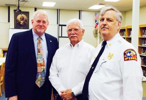 Central Middle School Principal Charlie Jehlen, left, poses with Nederland Police Chief Darrell Bush and Nederland Fire Chief Gary Collins during the annual First Responders Day Breakfast in honor of 9/11 Friday morning in the Central Middle School library.