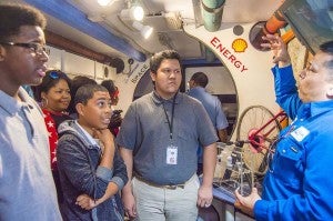John Mamrrique, Motiva project engineer, right, teaches eighth grade science students about different types of energy in the Texas Alliance for Minorities in Engineering Trailblazer at Abraham Lincoln Middle School in Port Arthur Friday morning.