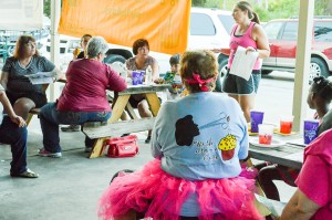 Kathy Williams, Curves of Nederland team captain, center, listens while Kara Baker Booth, Relay for Life of Mid- and South Jefferson County event co-lead, explains the proposed setup along Boston Avenue during the 2016 Retro Relay Kickoff meeting Tuesday night at the Nederland Heritage Festival Pavilion.