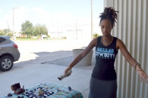 Robyn Prevost with Touch of Peace Massage Therapy in Houston lights a stick of white sage at her booth during a family fitness day E3Retreats in Port Arthur on Saturday. Mary Meaux/The News 