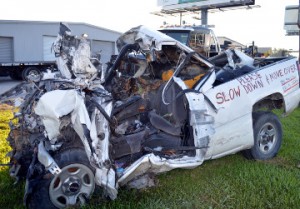 A crashed truck sits in front of SWAT Towing and Recovery at the corner of Twin City Highway and Hogaboom Road reminding motorists to slow down and move over. The truck was driven by a League City man who crashed into an industrial truck being towed by a SWAT driver Frank Amerson. Both men died. Mary Meaux/The News