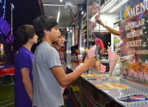 Jose Ceja grabs a sack during opening night of the Groves Pecan Festival at Lion’s Park on Thursday. Mary Meaux/The News