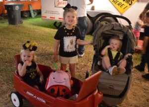 Spencer Delage, left, Peyton Delage and Aubree Bell enjoy the Groves Pecan Festival on Friday. Mary Meaux/The News