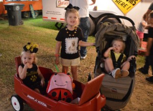 Spencer Delage, left, Peyton Delage and Aubree Bell enjoy the Groves Pecan Festival on Friday. Mary Meaux/The News 