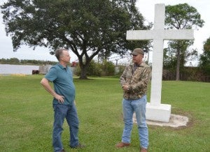 The Rev. David Birdsong of Southside Baptist Church, left, speaks with Port Neches-Groves High School graduate and Sulphur, La. resident Kip Coltrin who drove to the park to “Stand to Post” before the cross at Port Neches Riverfront Park on Friday. The Freedom From Religion Foundation is asking the city to take the cross down or move it to private property. Mary Meaux/The News 