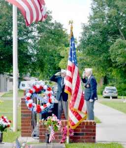 World War II veterans and members of the Veterans of Foreign Wars Post 4820, Otis Barnes, left, and Jim White salute during the playing of taps during a Memorial Day Celebration at Oak Bluff Memorial Park in Port Neches on Monday.