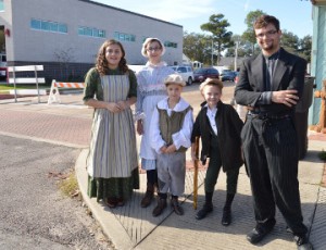 Port Arthur Little Theater cast members from the current production of A Christmas Carol walk the streets of Boston Avenue in Nederland during Christmas on the Avenue on Saturday. Mary Meaux/The News