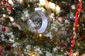 A clear Christmas bulb features a handwritten message for a deceased loved one on the memorial tree at Oak Bluff Memorial Park in Port Neches. Mary Meaux/The News