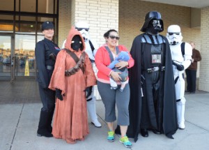 Star Wars fan Stephanie Cruz, who is also the mother of Kristofer Camacho, poses for a photo with Star Wars characters. Mary Meaux/The News