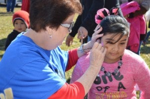Makaila Barajas, 8, gets her face painted by Jane Chapman during Easter in January Candy Drop at Memorial Baptist Church on Saturday. Mary Meaux/The News 