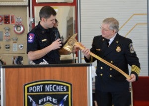 Port Neches Fire Captain Doug Bledsoe, left, presents retiring Fire Chief Steve Curran with a special ax during a retirement celebration on Friday in Port Neches. Mary Meaux/The News 