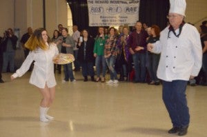 Kelsey Bolch, left, as “Risky Business,” dances with “Chef” Richard Schleiffer during Beans and Jeans at the Robert A. “Bob” Bowers Civic Center on Saturday. The event ushers in the Mardi Gras season. Mary Meaux/The News 