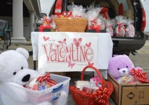 Valentine’s baskets and gifts, sold by friends Emma Guidry and Vera Ceaser, await a new home at their stand in the 3500 block of Twin City Highway on Saturday. Mary Meaux/The News 