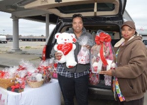 Emma Guidry, left, and Vera Ceaser show off some of the Valentine’s gifts they are selling at their stand in the 3500 block of Twin City Highway on Saturday. Mary Meaux/The News 