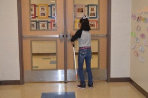 Sidney Navarro manuevers thorugh a hallway and to a door with the help of a cane at Robert E. Lee Elementary School. Mary Meaux/The News