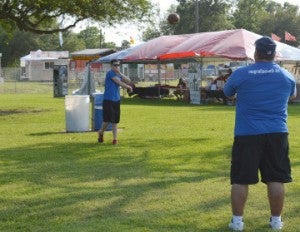 Rob Adams, left, and Robert Adams toss a football around before the start of RiverFest on Wednesday. Mary Meaux/The News