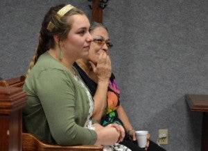Port Neches-Groves High School senior Alyssa Nunez and her grandmother Maria Nunez listen as Justice of the Peace Brad Burnett congratulates the student for overcoming challenges and changing her attendance problems as this year’s Shining Star award recipient on Friday. Mary Meaux/The News