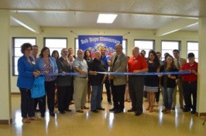Bob Hope School officials and school board members along with members of local chambers of commerce cut the ribbon at the new Bob Hope Elementary School on Monday. Mary Meaux/The News