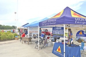 Vendors tend their tents that were set up for the event at Mid County Chrysler Dodge Jeep Ram. Lorenzo Salinas/The News