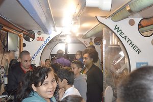 Students, teachers and instructors stand inside the 40-foot science-themed trailer of the Trailblazer at DeQueen Elementary. (Lorenzo Salinas/The News)