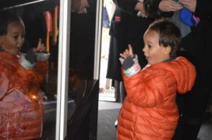 Andre Thomas, 4, reacts to seeing a miniature train and Christmas scene inside the Kansas City Southern Holiday Express train on Thursday. Mary Meaux/The News