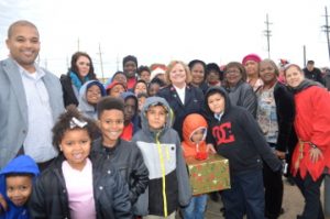 Port Arthur Mayor Derrick Freeman and his children, left, and Salvation Army Maj. Nancy Fuller, center and members of the women’s group, pose for a photo outside the Kansas City Southern Holiday Express train on Thursday. Mary Meaux/The News