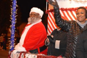 Santa Claus waves to the crowd during Port Arthur’s Annual Cultural Lighted Christmas Parade on Procter Street on Friday. Mary Meaux/The News