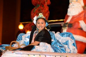A member of the Mexican Heritage Society’s royal court rides in Port Arthur’s Annual Cultural Lighted Christmas Parade on Procter Street on Friday. Mary Meaux/The News