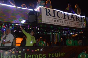 The Richard Industrial Group passes by with a festive gathering on its float. (Lorenzo Salinas/The News)