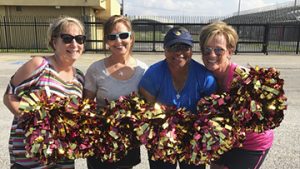 Thomas Jefferson High School cheerleaders take a break from practice for a photo op. The cheerleader alumni will participate for the first time in Total Krewe of Aurora Grand Parade on Saturday. Courtesy photo